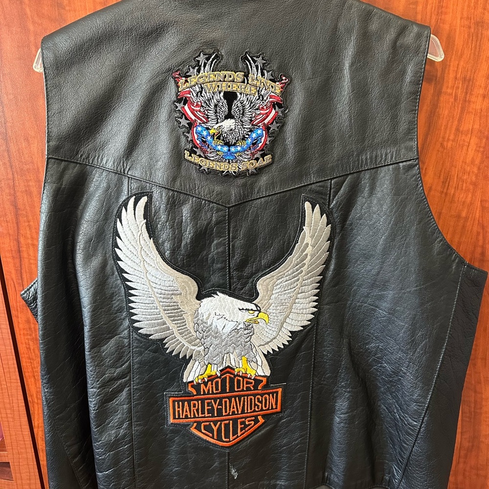 Black leather motorcycle vest with Harley-Davidson and Eagle  Patches